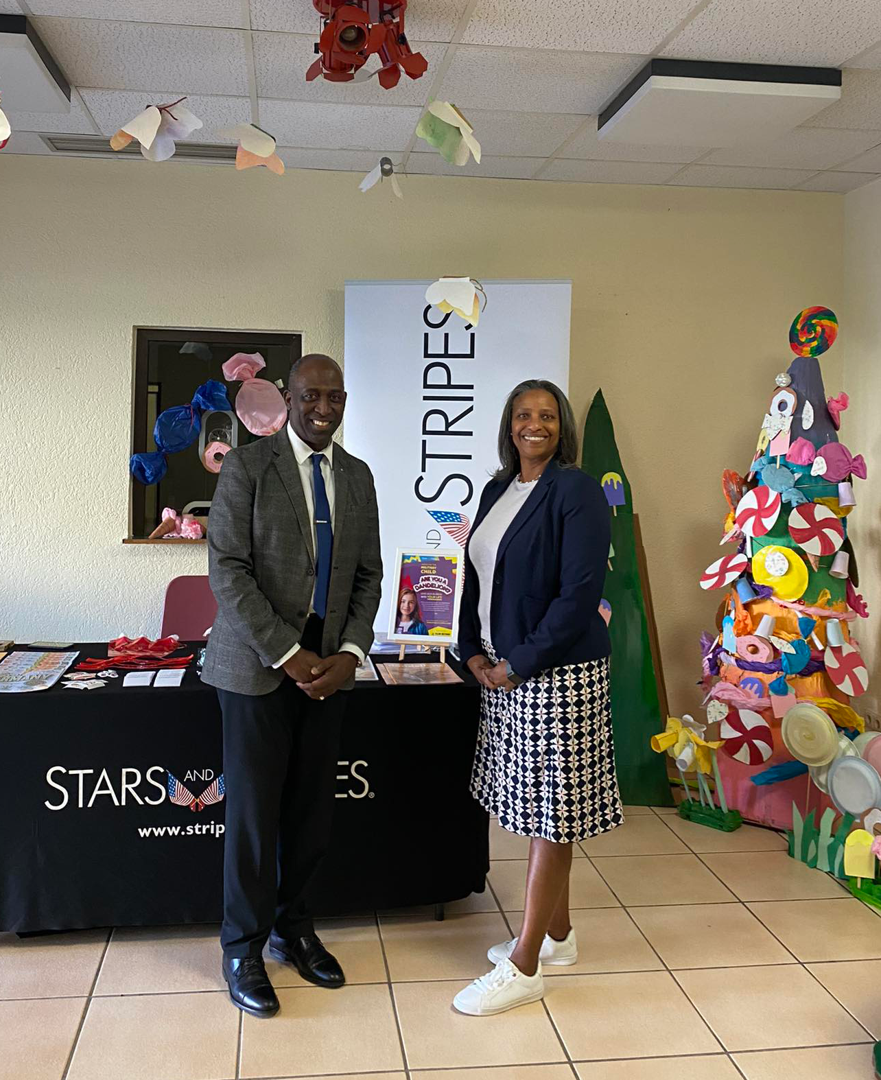 Mrs. Zamor and a representative from Stars and Stripes.